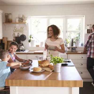 family interacting in the kitchen