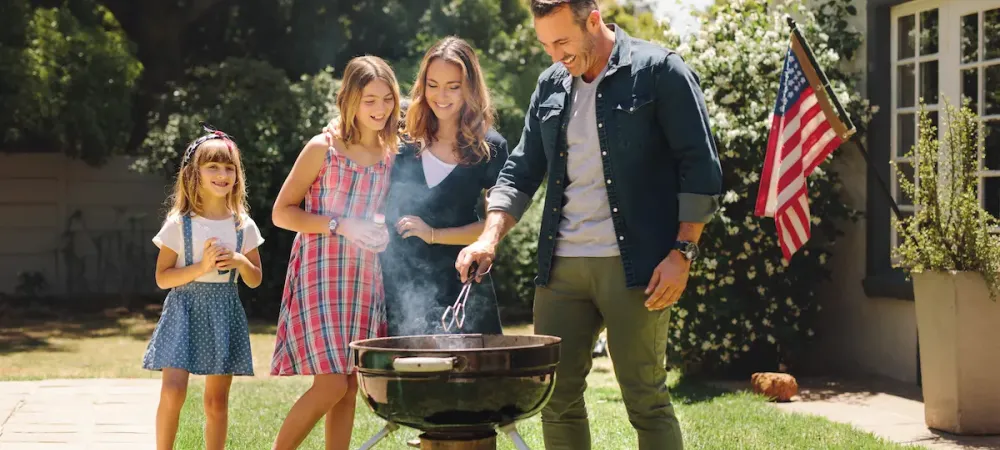 family cooking on grill