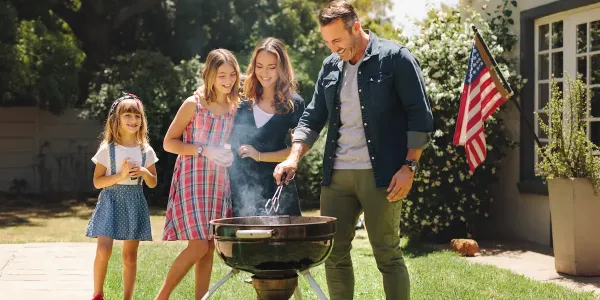 family cooking on grill