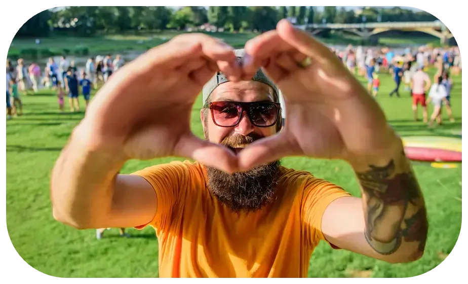 man creating heart with hands